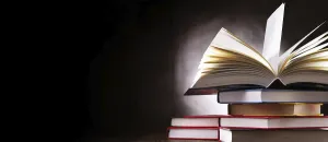Deserted Library Scene Impressions: A composition with an open book lying on a stack of other books