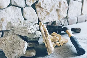 Fortress Architecture Impressions: Construction Hammer And Stack Flagstone Against The Wall Of Stone Closeup