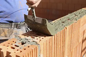 Handicraft Industry Impressions: Construction worker (bricklayer) on the building site