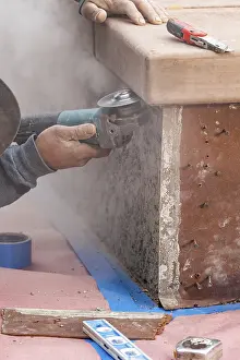 Manpower In Construction Impressions: Construction worker using grinder at construction site