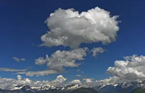 Blue Sky Cumulus Cloud Formation Impressions: Cumulus clouds over mountain range