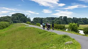 Cyclist On Cycle Path Impressions: Cyclist on a cycle path by the river