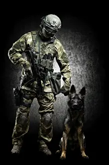 German Shepherd Breed Impressions: Dog handler posing in the studio with a trained shepherd