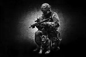 German Shepherd Breed Impressions: Dog handler posing in the studio with a trained shepherd