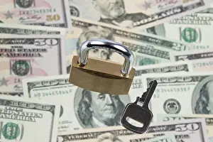 US Dollar Notes Impressions: Many dollar banknotes with a lock