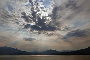 Dramatic Cloud Formation Impressions: Dramatic cloud formation, sunbeams behind dark clouds