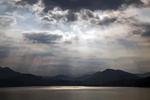 Dramatic Cloud Formation Impressions: Dramatic cloud formation, sunbeams behind dark clouds