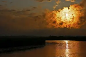 Dramatic Cloud Formations Europe Impressions: Dramatic cloud formation at sunset reflected in a calm river