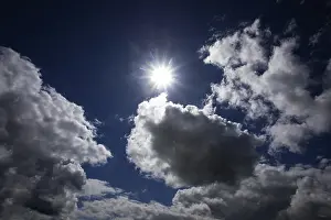 Cloudy Weather Forecast Impressions: Dramatic cloudscape with (cumulus) clouds and sunrays