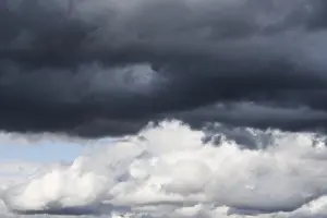 Atmospheric Cloudy Skies Impressions: Dramatic cloudy sky, dark thundercloud over light cumulus clouds