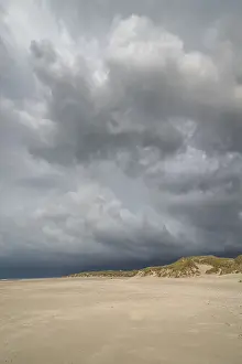 Deserted Sandy Ocean Beach Impressions: Dramatic storm clouds over beach and dunes