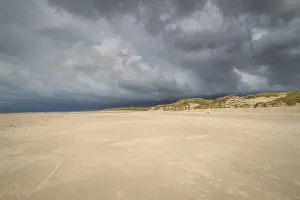 Cloudy Sky Over Dunes Impressions: Dramatic storm clouds over beach and dunes