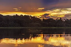 Dramatic Cloudy Skies Impressions: Dramatic sunset with clouds over a river in the Amazon