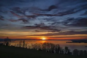 Deserted Lake Waterfront Scene Impressions: Dramatic sunset on the lake, clouds