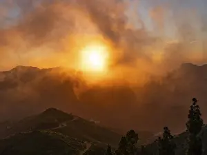 Cloudy Evening Sky Photography Impressions: Dramatic sunset lighting up the clouds and mist over the mountains