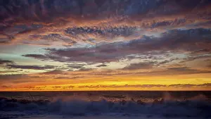 Cape Verde Sunset Impressions: Dramatic sunset with powerful cloud formations and breaking waves in the foreground
