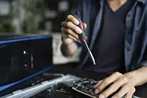 Electronic Repair Shop Impressions: IT Engineer installing Hardware Equipment Development Facility Engineer Maintenance computer Motherboard Electronic