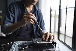 Electronic Repair Shop Impressions: IT Engineer installing Hardware Equipment Development Facility Engineer Maintenance computer Motherboard Electronic
