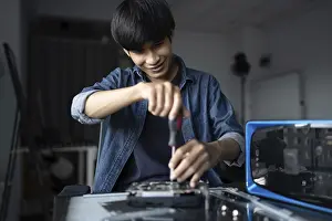 Electronic Repair Shop Impressions: IT Engineer installing Hardware Equipment Development Facility Engineer Maintenance computer Motherboard Electronic