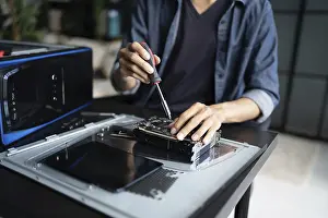 Electronic Repair Shop Impressions: IT Engineer installing Hardware Equipment Development Facility Engineer Maintenance computer Motherboard Electronic