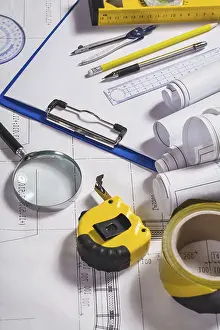 Magnifying Glass Image Impressions: Engineer tools on blueprint
