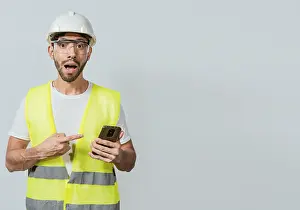 Construction Industry Professional Impressions: Engineer using and pointing at cellphone
