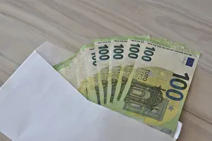 Corruption Symbol Impressions: Many one hundred euro notes in an envelope on a table