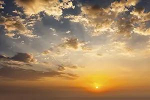 Evening Landscape Photography Impressions: Evening sunset sky with sun and dramatic clouds