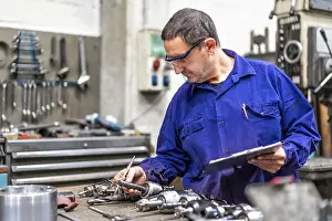 Factory Worker Impressions: Factory worker operator of the numerical control sector measuring the drill bits