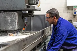 Latin American Laborer Impressions: Factory worker operator in the numerical control sector preparing a machine