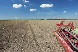 Dutch Windmill Landscape Impressions: Fields with young vegetable fields and detail of planting machine