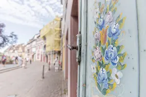 Deserted French Village Impressions: Flower pattern painted on a window pane