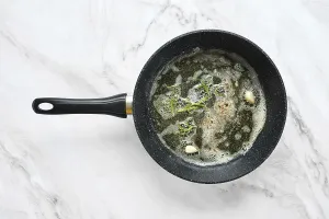 Marble Surface Impressions: A frying pan is on a marble surface