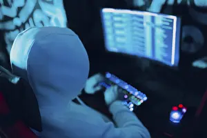 Hacker Attack Prevention Impressions: Hacker using computer malware virus software and hacking binary code green digital interface