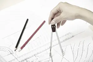 Engineering Blueprint Impressions: Hand of engineer working on a construction plan