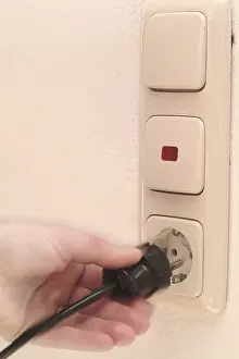 Accident Prevention Tips Impressions: Hand pulls plugs from plug socket