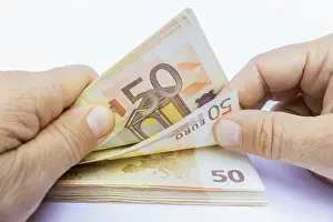 Paper Money Stack Impressions: Two hands counting stack of 50 euro notes