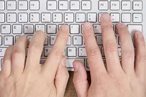 Empty Workspace Impressions: Hands typing on a computer keyboard