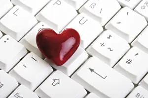 Red Coloured Heart Shape Impressions: Heart lying on a computer keyboard