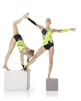 Circus Artist Training Impressions: Two high skill acrobats exercise program on cube isolated