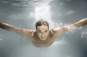 One Person Swimming Impressions: An image of a man diving in a pool