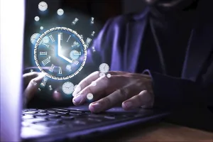 Capital Market Protection Impressions: Image of a man using the computer with a clock indicating the time of use of the pc