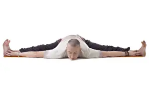 Male Yoga Model Impressions: Image of yogi posing on split, isolated over white backdrop