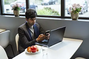 Remote Work Lifestyle Impressions: A indian man multitasks efficiently using a smartphone