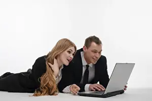 Teamwork And Technology Impressions: Two individuals engaged in a collaborative activity