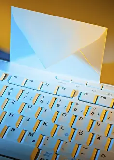Email Communication Impressions: The keyboard of a computer and an envelope