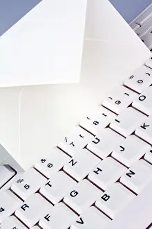 Email Communication Impressions: The keyboard of a computer and an envelope