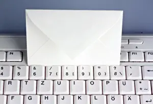 Email Communication Impressions: The keyboard of a computer and an envelope