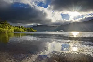 Dramatic Clouds Landscape Impressions: Lake with dramatic clouds and sun in spring