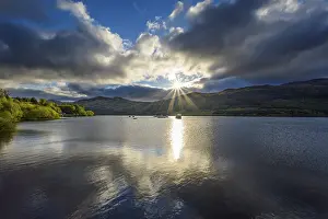 Springtime Landscape Photography Impressions: Lake with dramatic clouds and sun in spring